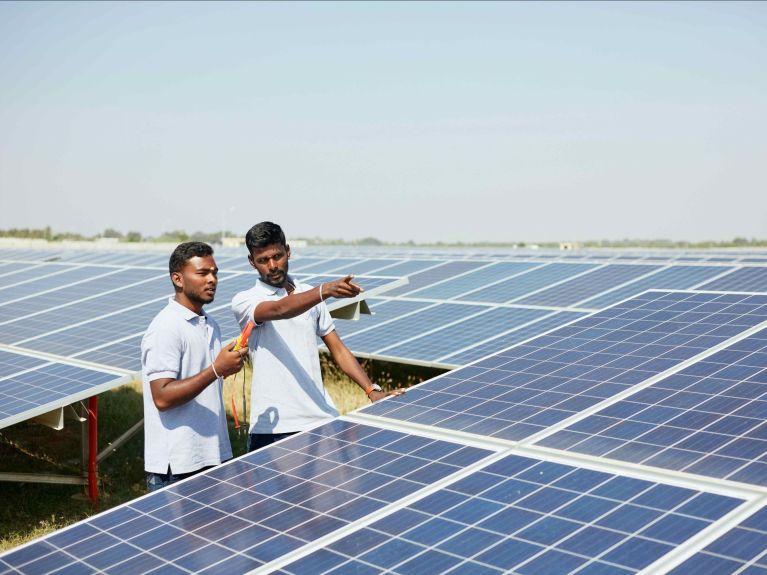 Solar technical team inspecting photovoltaic panels